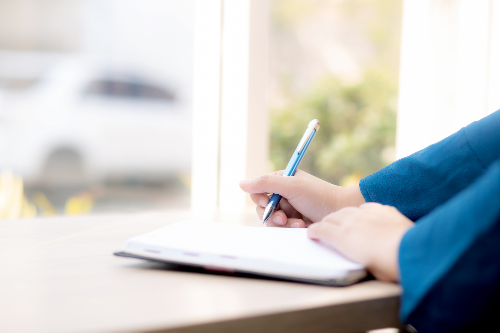 Closeup of Writer Writing on Notebook